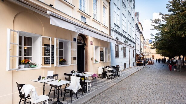 Een straat met terrasjes van een restaurant genaamd Dvorak Residence.