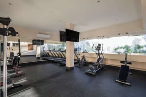 A gym with treadmills, stationary bikes, and weight machines.