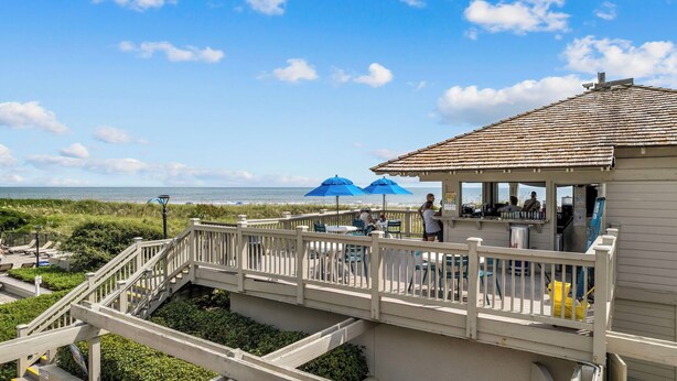 A beachside restaurant with outdoor seating, a covered area, and a view of the ocean. - Family-Friendly 2BR Condo Near Beach & Barefoot Landing (Myrtle Beach)