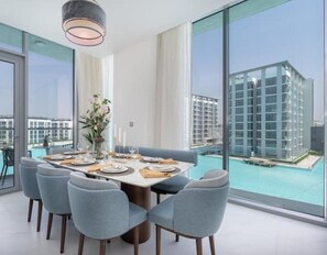 Enjoy meals with friends and family in this stylish dining area, featuring a large table and comfortable seating for six.