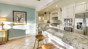 A modern kitchen with white cabinetry, a granite countertop, and stainless steel appliances. - 3 Mi to Downtown Tyler: Home w/ Fenced Yard! (Tyler)