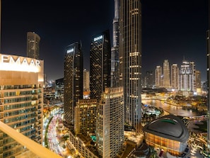 A nighttime cityscape with prominent EMAAR branded buildings, a river, and a stadium. - Vogue, Downtown Forte Opera District near Burj Khalifa and Dubai Mall (Dubai)