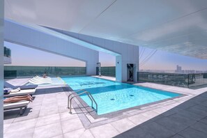 Una piscina infinita en la azotea con vistas despejadas al horizonte de la ciudad.