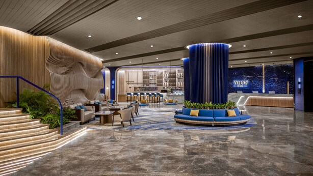 A modern lobby with a curved staircase, seating areas, and a reception desk. - voco Bandung Setiabudi by IHG (Bandung)