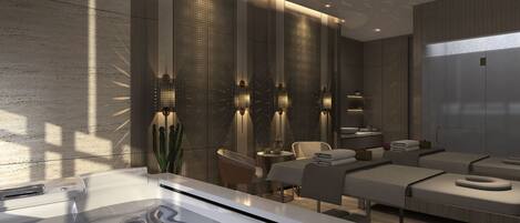 A modern spa room with a large bathtub, seating area, and a wall with vertical light fixtures.