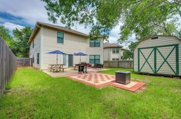 Large backyard with patio, grill, and firepit