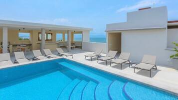 Outdoor pool, open 9:00 AM to 10:00 PM, pool loungers