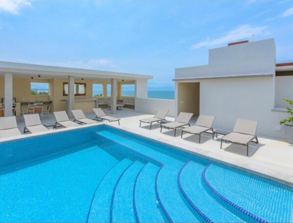 Outdoor pool, open 9:00 AM to 10:00 PM, pool loungers