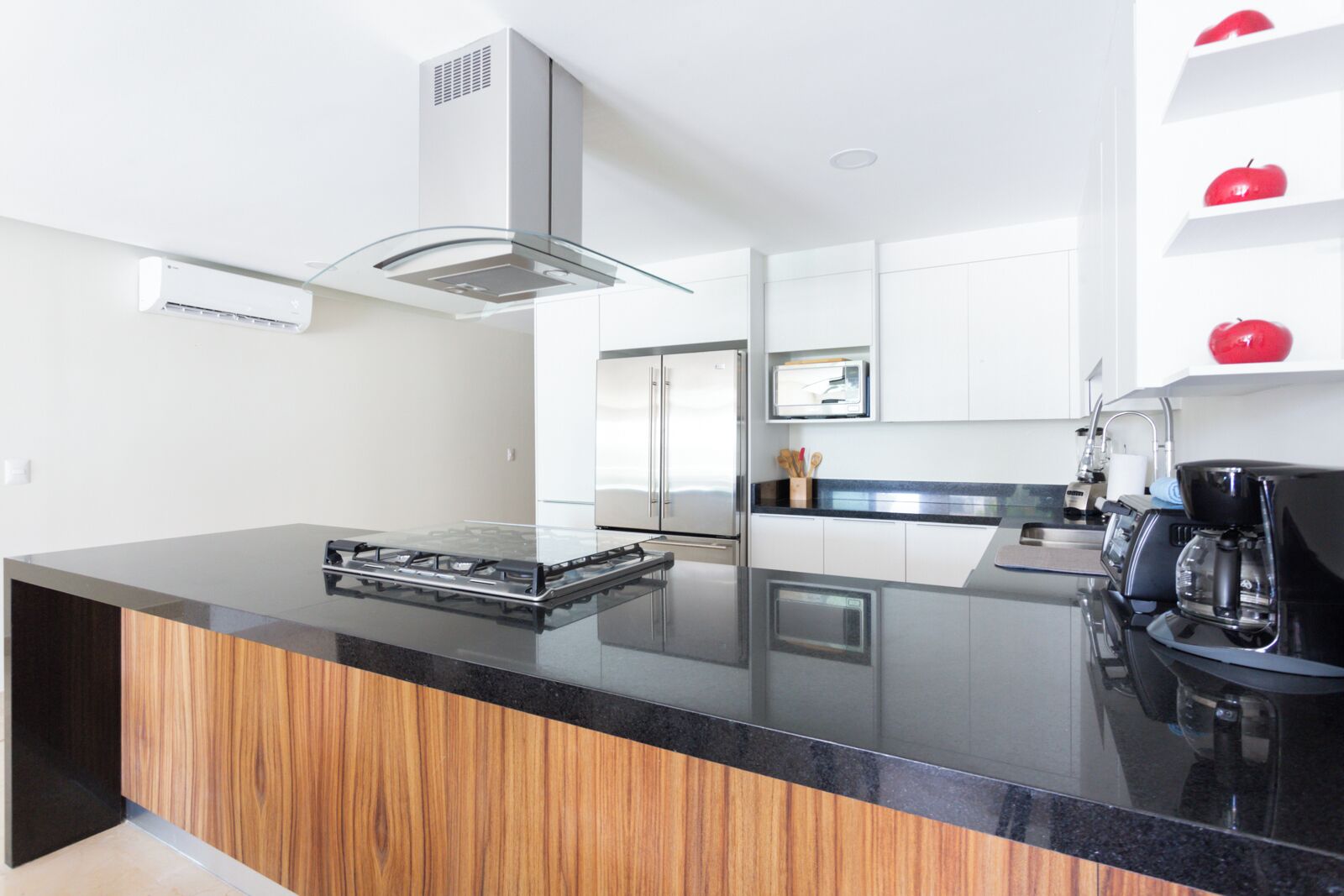 A modern kitchen with a central island, stainless steel appliances, and a minimalist design.