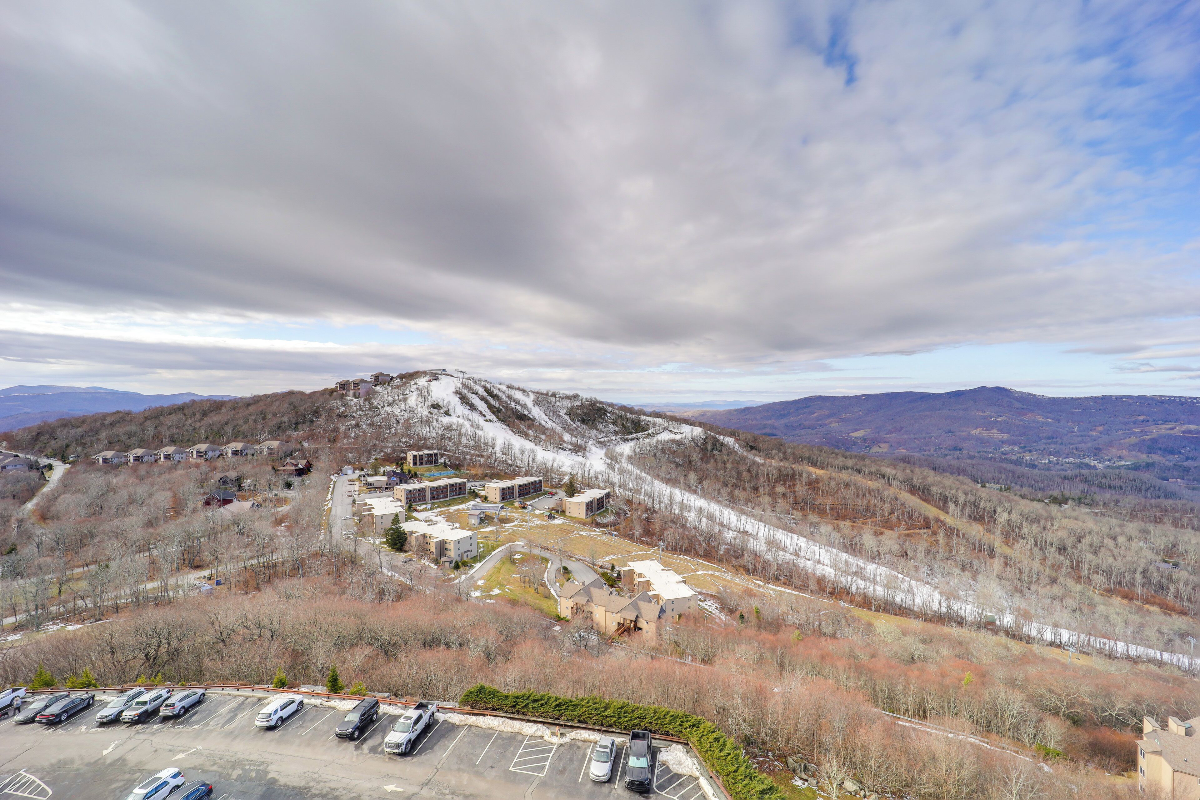 A mountainous area with a parking lot and buildings.