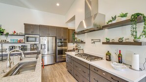 A modern kitchen with stainless steel appliances, wooden cabinets, and a white countertop. - Mtn Views, Pool & Hot Tub: Phoenix Oasis (Phoenix)