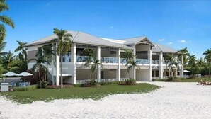 Un hôtel en bord de mer doté de nombreux balcons, de palmiers et d’une plage de sable.