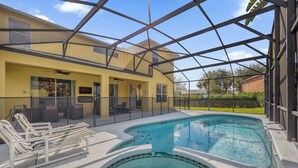 A pool area with lounge chairs, a glass-enclosed structure, and a sign indicating a Netflix service. - Pool, Themed Rooms, Resort (Kissimmee)