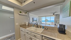 A modern kitchen with a large island, a built-in oven, and a coffee maker. - Tower 3-102 Long Beach Resort. Free Beach Chair Service! (Panama City Beach)