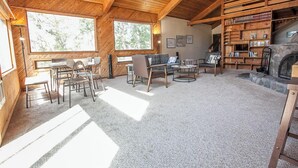 A cozy living room with a fireplace, wooden bookshelves, and a comfortable seating area.