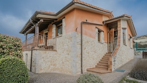 A house with a stone facade, a balcony, and a staircase leading to the entrance. - Country House 'La Cardeñuela' with Mountain View, Private Terrace and Wi-Fi (Burgos)