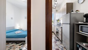 A bedroom with a bed, a nightstand, and a bedside lamp. - Apartment 'Vista Mare A 150 Mt Dalla Spiaggia' with Sea View, Private Terrace and Air Conditioning (Pietra Ligure)
