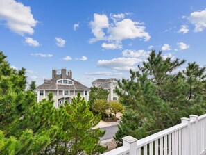 A residential property with a two-story house, a driveway, and a white fence. - Private Beach Access, Ocean Views, Modern Design (North Bethany Beach)