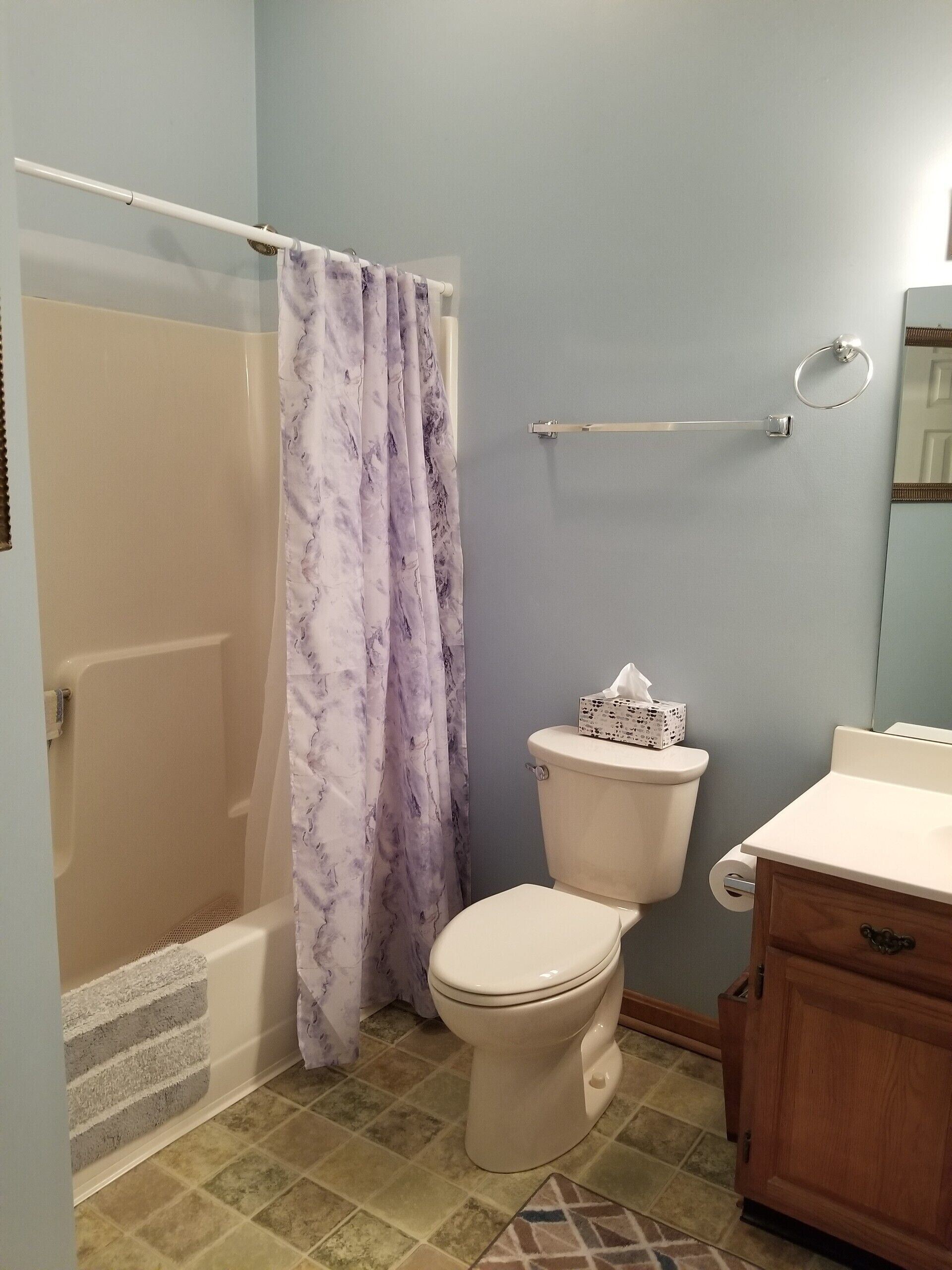 A bathroom with a bathtub, toilet, and vanity.