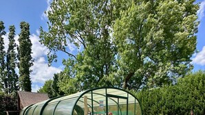 Une structure entièrement vitrée dotée d’un espace extérieur aménagé et d’une piscine.