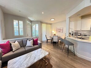 Relax in a comfortable living space with a sofa, dining area, and kitchen.