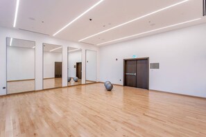 A spacious room with wooden flooring, large mirrors, and exercise balls. - Vogue Downtown Forte Opera District near Burj Khalifa and Dubai Mall (Dubai)