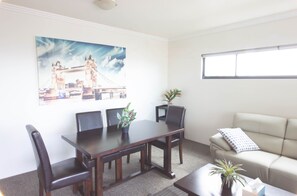 Apartment, Balcony, City View | Living area | TV