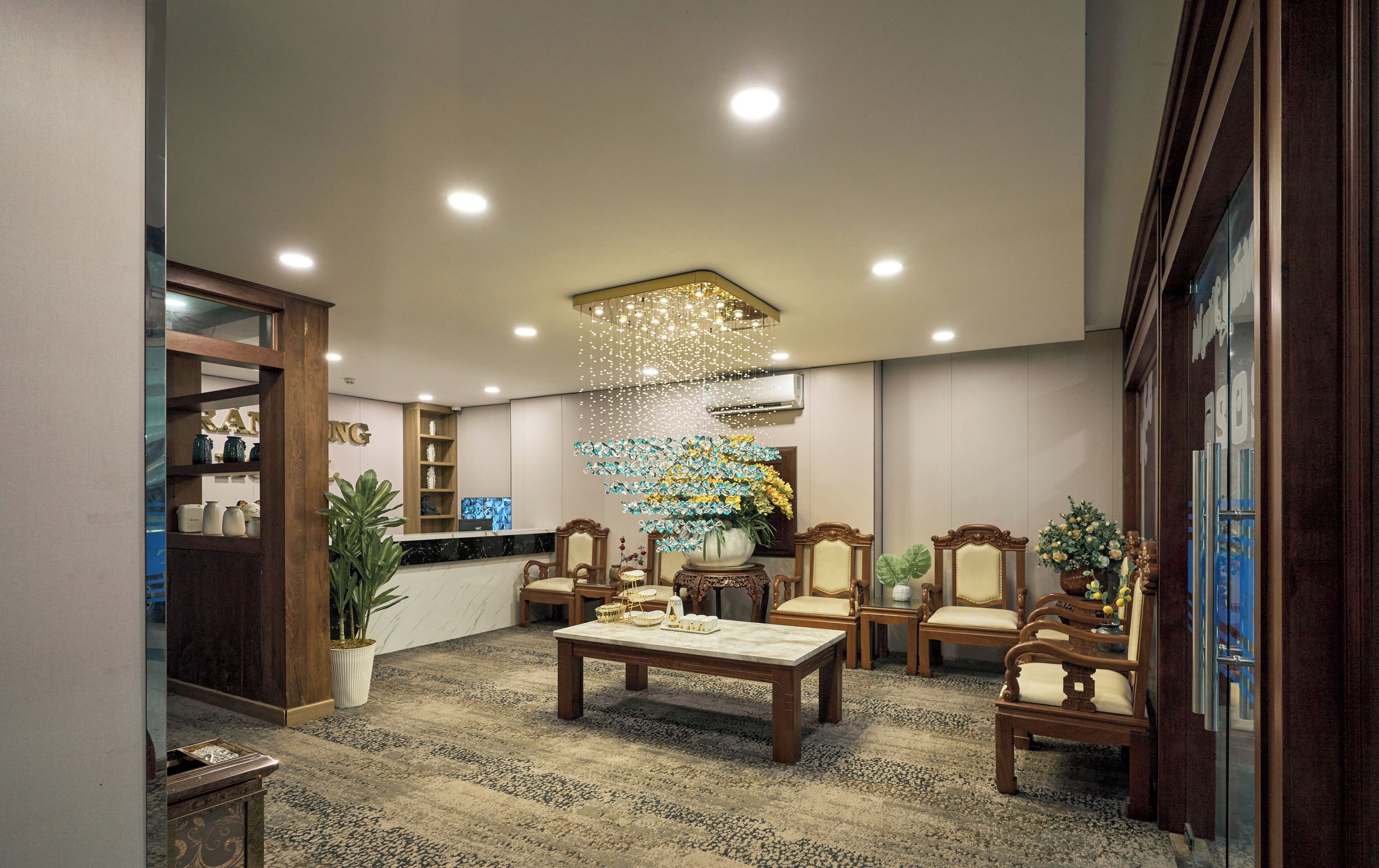 A lobby with a reception desk, seating area, and decorative elements.