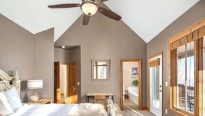 A bedroom with a bed, a desk, a ceiling fan, and a large window. - Large, Ski-in/Ski-Out, Hot Tub, Wet Bar, Sleeps 16 (Beech Mountain)