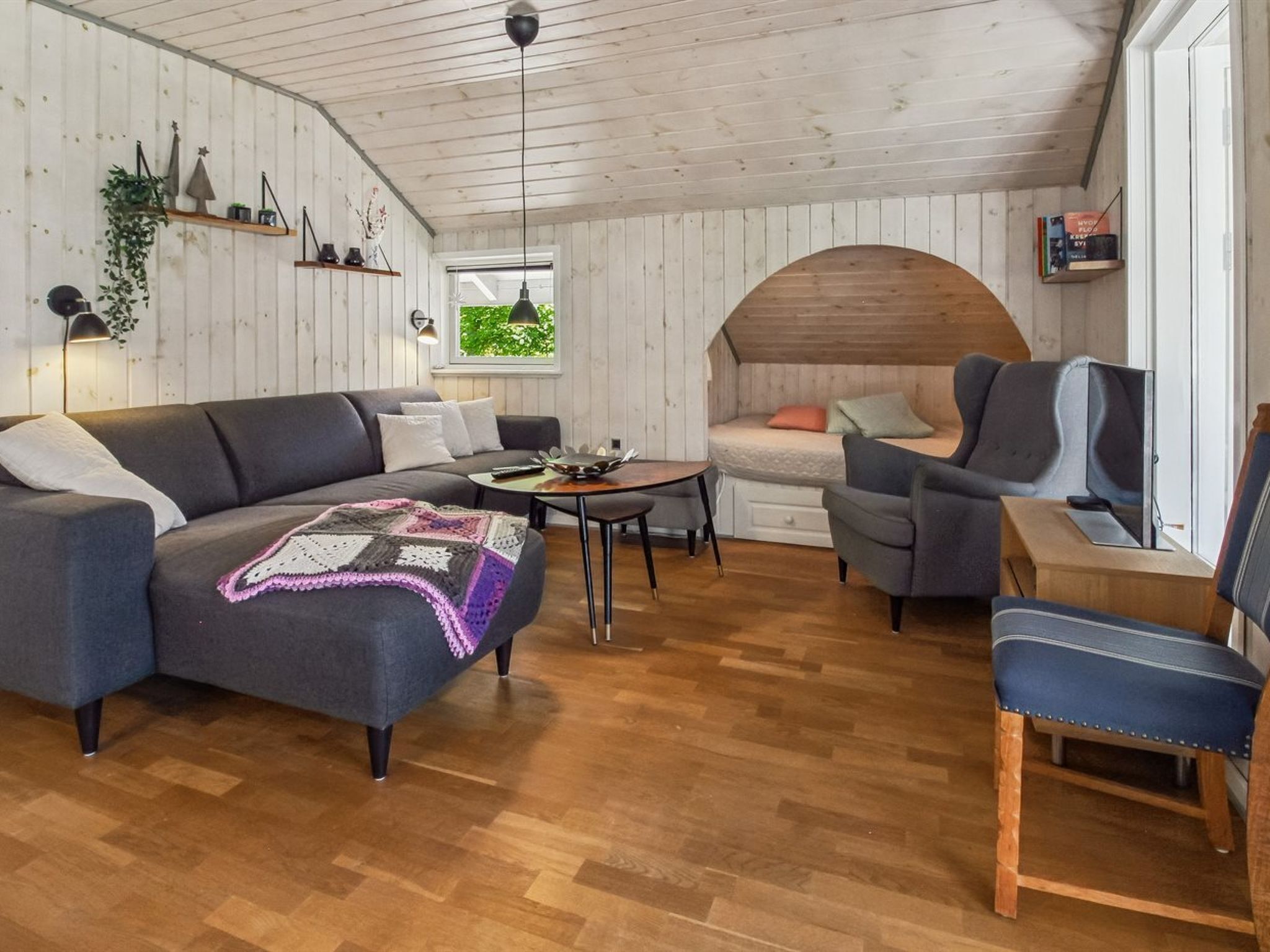 A cozy room with a sofa, armchair, and a small table.