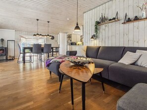 A modern living room with a sofa, a coffee table, and a fireplace.