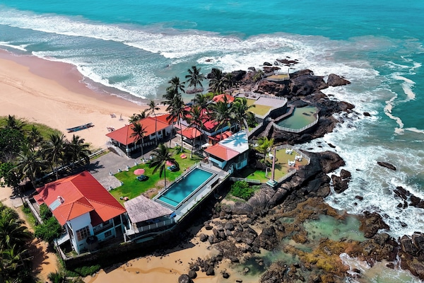 On the beach, white sand, sun loungers, beach umbrellas