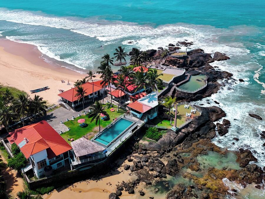 On the beach, white sand, sun loungers, beach umbrellas