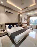 Deluxe Room, City View | Desk, laptop workspace, blackout drapes, iron/ironing board