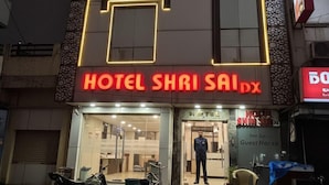A hotel named "HOTEL SHRI SAIDX" with a modern facade, a visible entrance, and a signboard. - Hotel Shri Sai Deluxe - 1 Min from Adarsh Nagar Metro | Couple, Business, and Family Friendly (New Delhi)