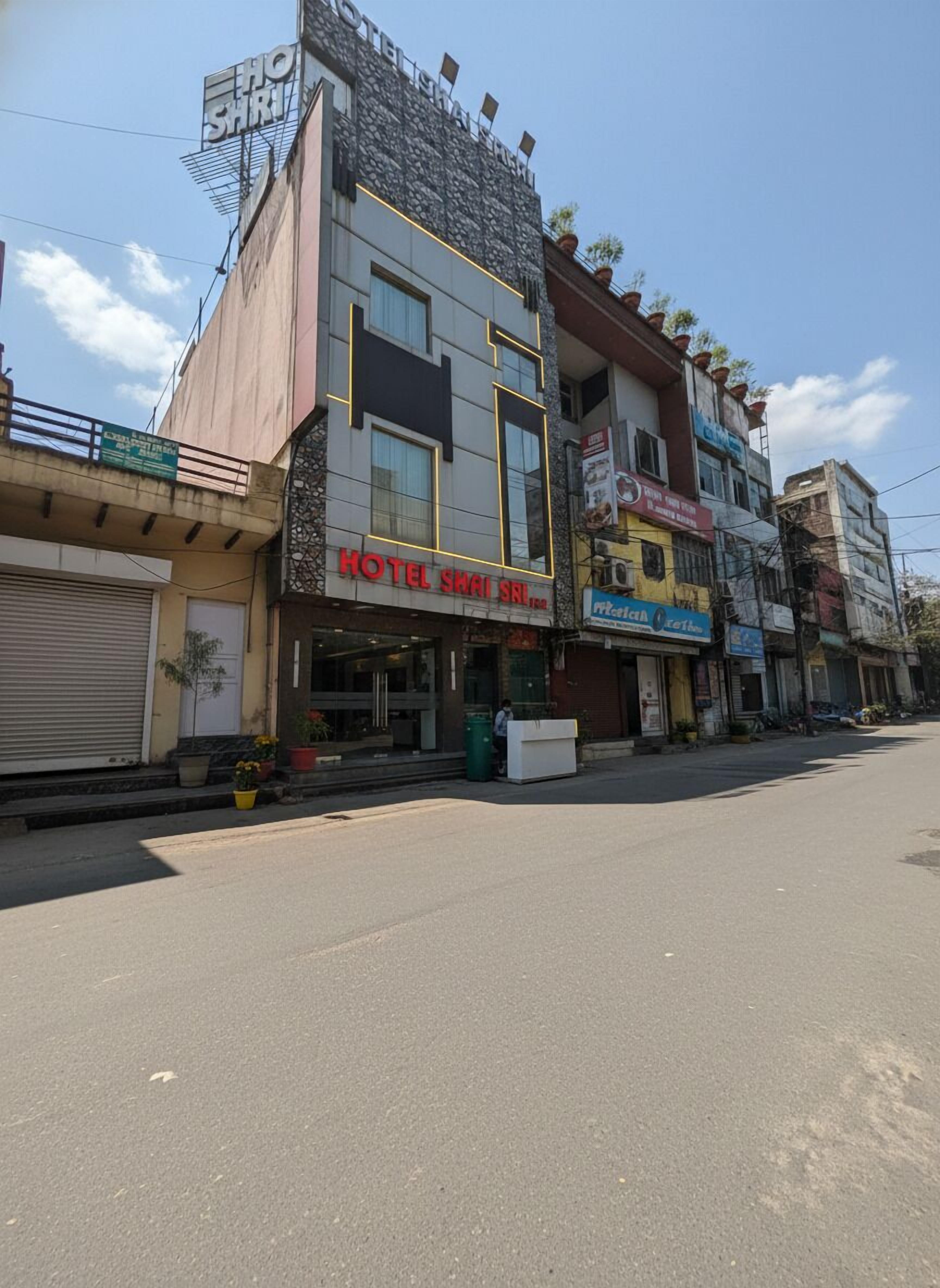 A multi-story building with a sign for 'HOTEL SHAI SRI'.