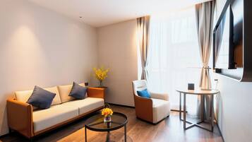 Executive Studio Suite | Living room | 43-inch LCD TV with cable channels
