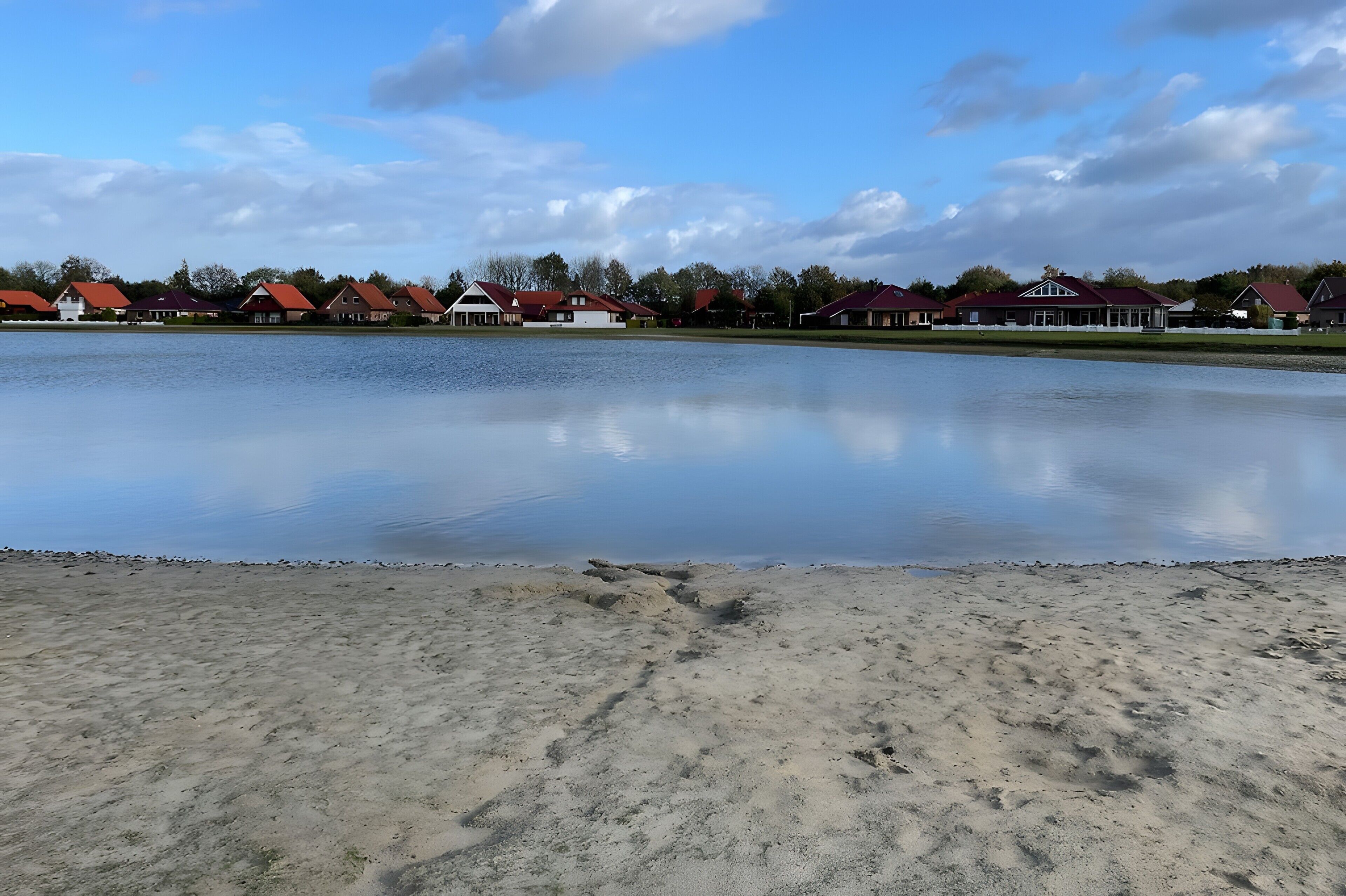 A lake with houses in the background.
