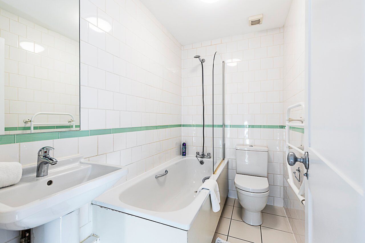 A bathroom with a sink, bathtub, and toilet.