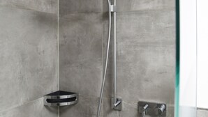 A shower with a handheld showerhead, a wall-mounted faucet, and a handheld showerhead. - Apartment 'Nr 2' with Mountain View, Shared Terrace and Wi-Fi (Vaihingen)