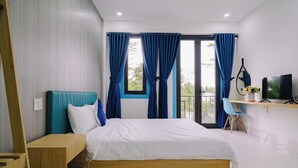 Une chambre à coucher moderne avec un lit, un bureau et un téléviseur.
