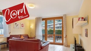 A living room with a brown leather sofa, a small table, a TV, and a glass cabinet. - Apartment 'No. 3c' with Private Terrace and Wi-Fi (Titisee-Neustadt)
