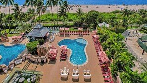 A resort with multiple swimming pools, lounge areas, and a beach view. - Luxury Beach Condo with Exclusive Resort Amenities 1016 (Miami Beach)