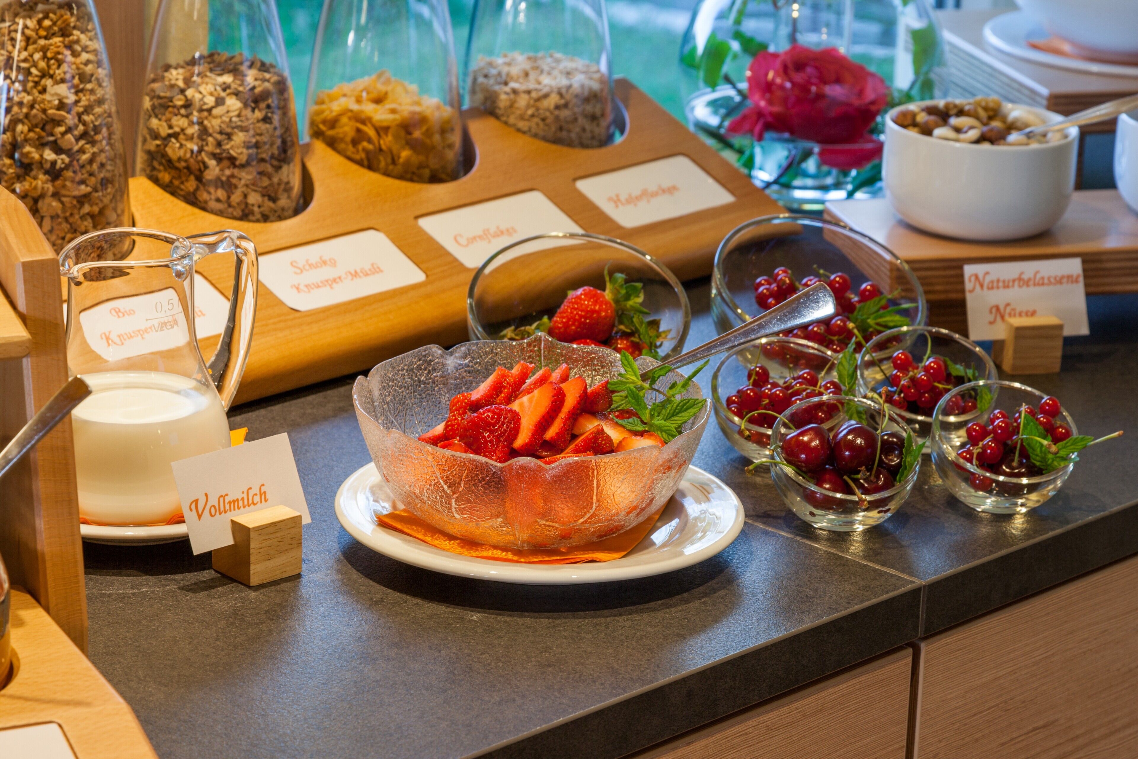A breakfast buffet with various food items and labels.