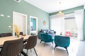 A modern living room with a sofa, chairs, and a dining table. - Tranquil Stay Near Beach by Sea N' Rent (Nahariya)
