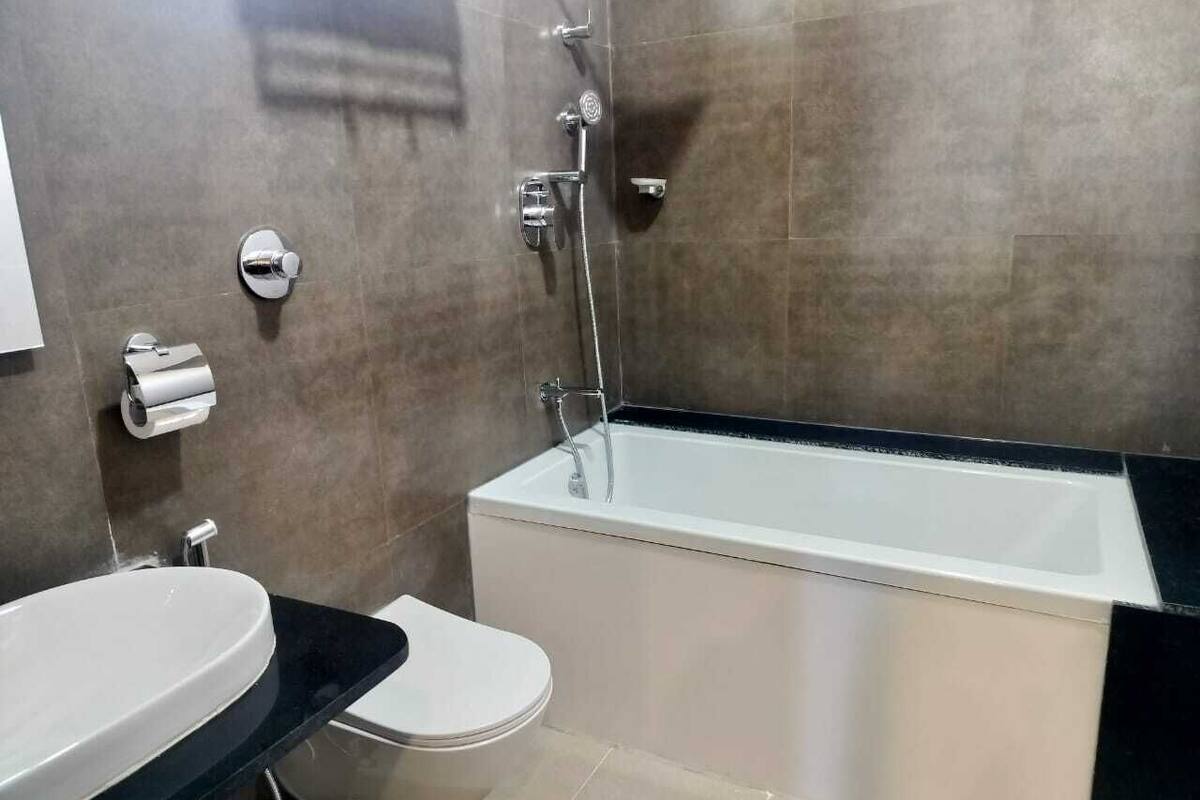 A modern bathroom with a bathtub, toilet, and sink.