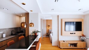 A modern kitchen with a central island, wooden cabinets, and pendant lighting. - Belgrade Rooftop Experience, Modern Luxury & Views (Beograd)