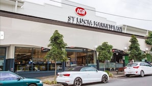 A building with a sign reading "IGA ST. LUCIA MARKETPLACE". - Affordable Studio – Steps from UQ/ Shops/ Transit (Saint Lucia)