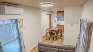 A compact living space with a sofa, dining table, and kitchenette. - TE HOUSE Osaka-Tennoji (Osaka)