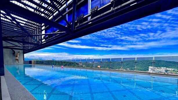 A swimming pool with a clear view of the surrounding landscape and power lines. - Mossaz by Manhattan Group  (Petaling Jaya)